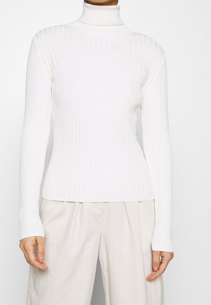 Pull à col roulé blanc à côtes, à manches longues, de longueur mi-thigh, fabriqué en maille douce, avec un design ajusté et une surface texturée.