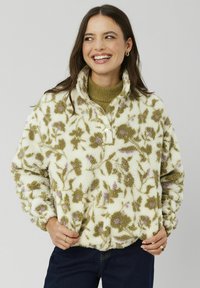 Pull en polaire à motifs floraux en crème avec des fleurs vertes et lilas. Doté d'un col zippé à mi-hauteur et d'un tissu texturé. Coupe confortable.