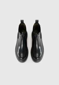Black leather ankle boots with a smooth surface, elastic side panels, and pull tabs; features a rounded toe and rubber outsole.