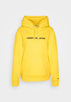 Felpa gialla con tasca frontale, cappuccio con cordino e logo "TOMMY JEANS" ricamato. Tessuto morbido con polsini e orlo a coste.