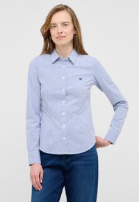 Blue and white striped button-up shirt with a collar, long sleeves, and a small logo detail on the chest, made from lightweight fabric.
