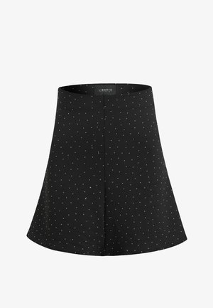 Gonna nera a linea A con piccoli pois bianchi e una cucitura centrale, con etichetta "Liberté Copenhagen" all'interno della fascia in vita.