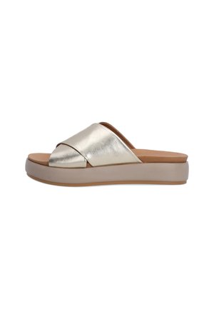Metallic gold slide sandals with crossed straps, beige insole, and a light brown rubber sole. Smooth texture and slightly elevated platform.