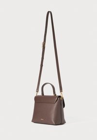 Brown leather handbag with a structured shape, top handle, and adjustable strap. Features a flap closure and gold-tone hardware accents.