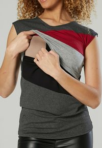Short-sleeve top with gray, black, and burgundy stripes; stretchy fabric; layered design revealing an inner panel for ease of wear.