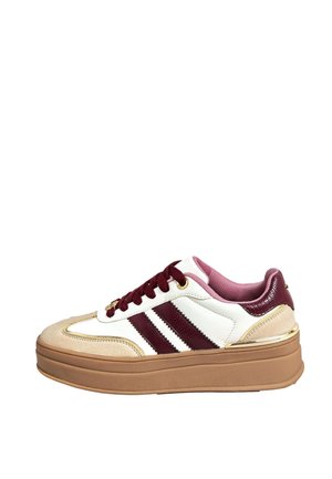 White platform sneaker with beige suede toe, maroon stripes and laces, pink inner lining, and tan thick sole with gold accents.