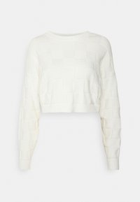 Vit kortärmad stickad tröja med ett texturerat rutmönster, ribbade ärmslut och krage, samt långa ärmar. Mjukt och stretchigt tyg.