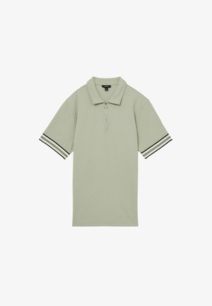 Hellgrünes Polohemd mit kurzen Ärmeln, strukturiertem Stoff, Reißverschluss vorne und schwarz-weißen gestreiften Akzenten an den Ärmeln.