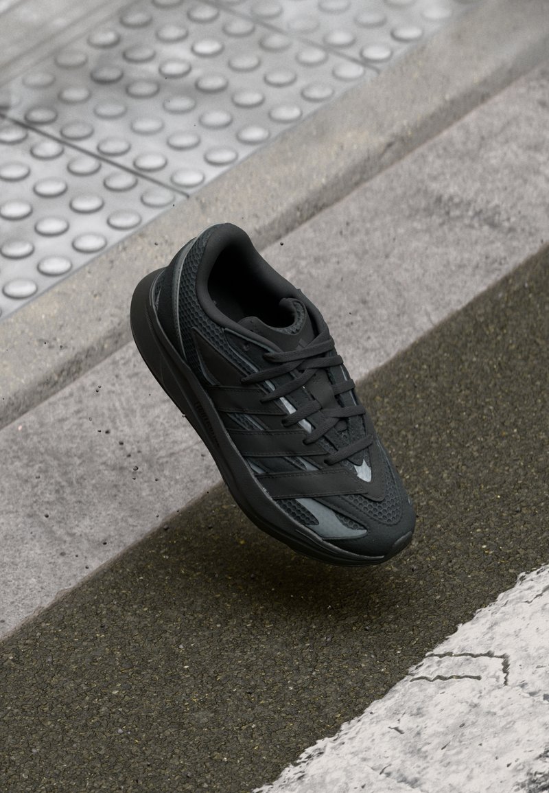 Mustad spordijalats võrkmaterjalist pealiskihi, kummist tallaga ja nööbitava paelaga. Omab tekstuurseid mustreid ja stiilseid detaile.