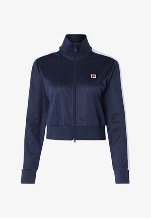 Chaqueta corta con cremallera en azul marino, con rayas verticales, cuello alto y rayas de acento en blanco en las mangas. Presenta un pequeño logo en el pecho.