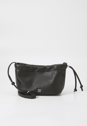 Black leather bag with a soft texture, cinched top, and adjustable strap. Features a small silver logo on the front.