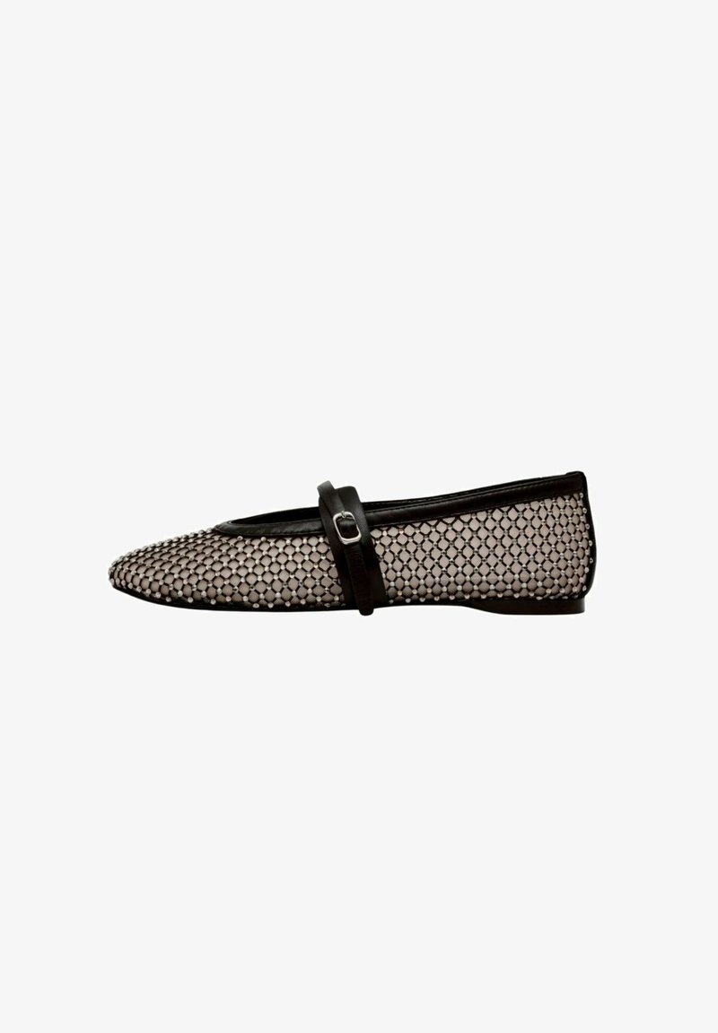 Black and white flat shoe with mesh fabric featuring a patterned design, rounded toe, and a black strap across the instep with a metal buckle.