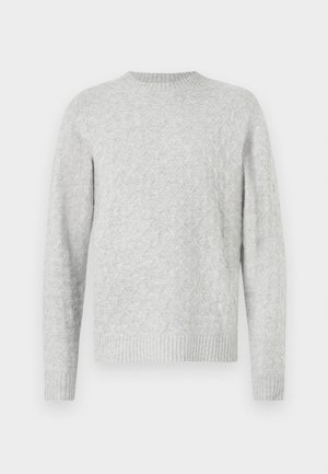 Hele halli kudum kootud sviiter, millel on tekstureeritud rombimuster, ümar kaelus ning soonikkoes mansetid ja alläär. Tavaline lõige, pikaaelised varrukad.