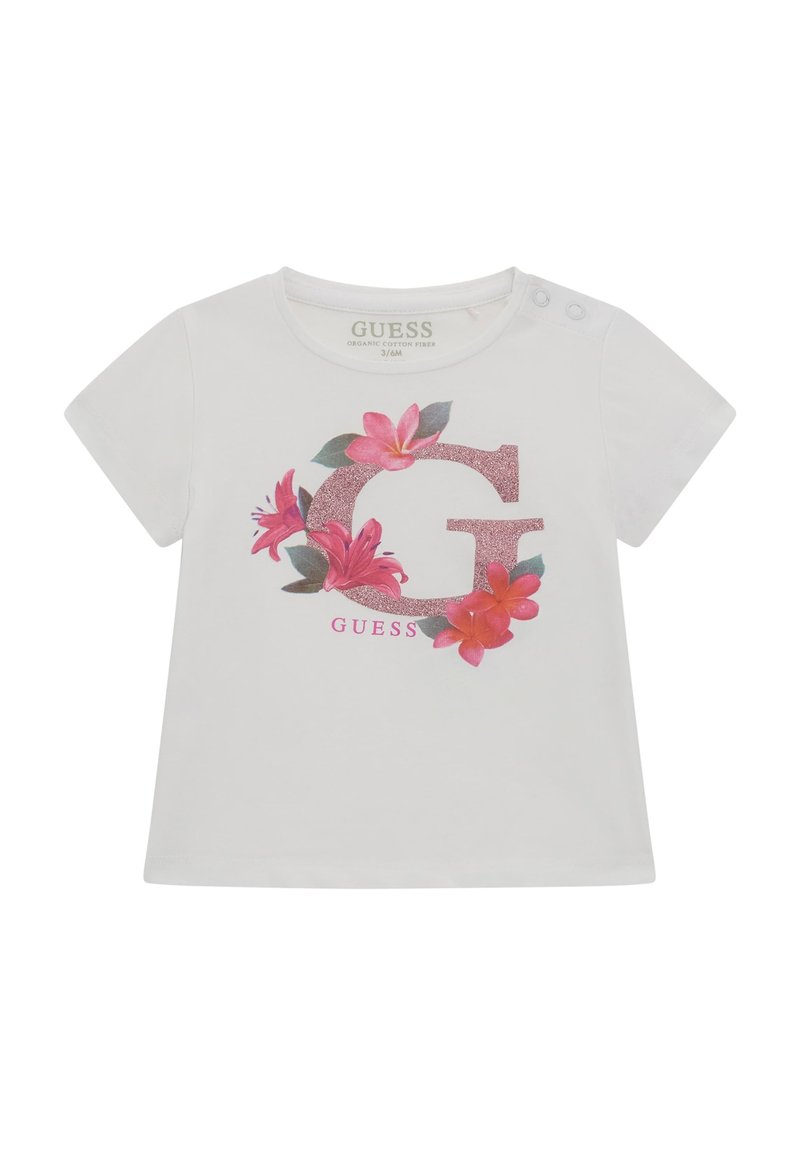 Hvid t-shirt i økologisk bomuld med et glitrende pink bogstav "G" omgivet af blomsterdesign i pink og grøn, med trykknapper på skulderen.