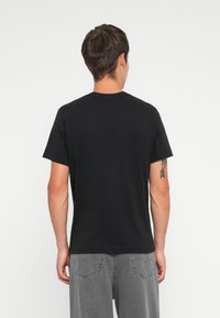 Black short-sleeve t-shirt with a crew neck, made of soft fabric. Features a simple design without notable patterns or accents.