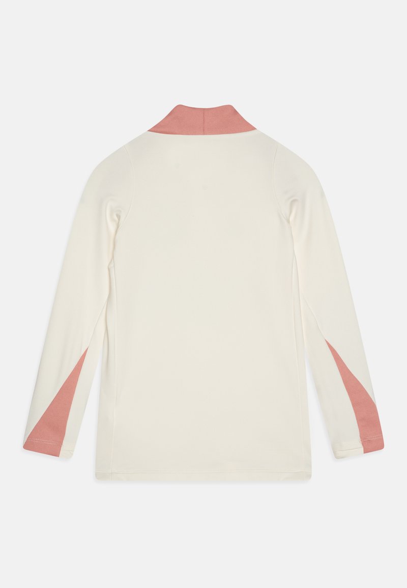 T-shirt à manches longues en crème avec un col rose. Présente des accents roses sur les côtés. Tissu doux avec une texture lisse.