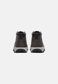 Dark gray leather ankle boots with black accents, featuring a padded collar, pull tab, and a white rubber outsole with textured tread.