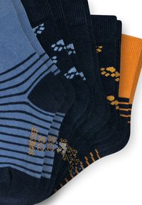 Set of four socks in various colors: dark blue, light blue, dark navy, and orange with striped and patterned designs for visual interest.