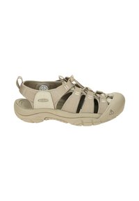 Beige outdoor sandal with elastic straps, rubber toe cap, and textured sole. Features adjustable bungee closure and ventilated design.