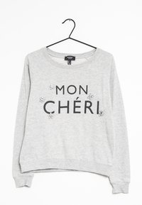Jasnoszara bluza z czarnym napisem "MON CHÉRI." Zdobiona dekoracyjnymi cekinami, z okrągłym dekoltem. Miękka tkanina, ściągacze na mankietach i u dołu.