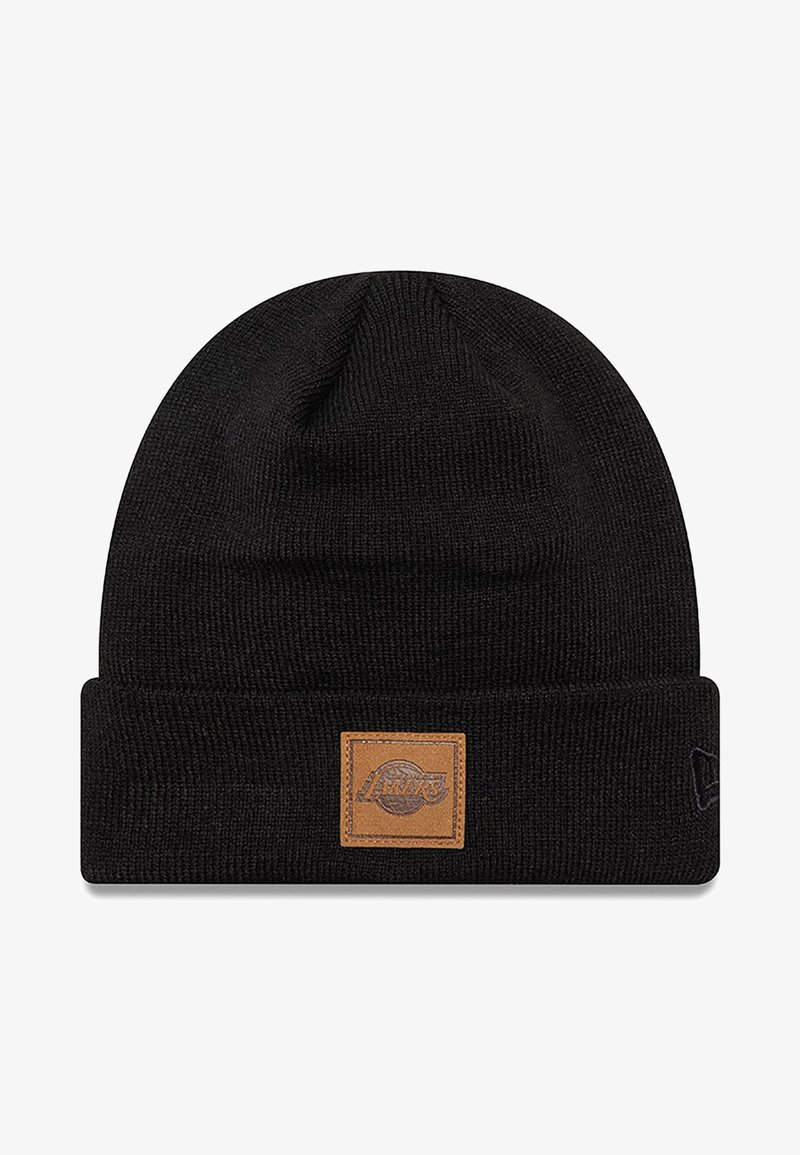 Black beanie hat made of knit material, featuring a brown leather patch with a logo. Simple rolled cuff design, smooth texture.