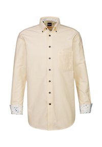 Hellgelbes langärmeliges Shirt mit einem Button-Down-Kragen, schwarzen Knöpfen und gemusterten Manschetten, die blaue, grüne und pinke Akzente aufweisen.