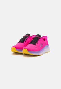 Hot pink athletic shoes with black laces, featuring a textured upper, a cushioned midsole, and a yellow outsole.