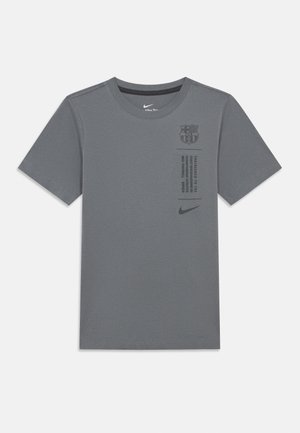 Gray Nike t-shirt with short sleeves, round neck, Barcelona logo, and printed text on the front. Simple design with smooth texture.