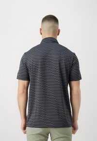 Short-sleeve polo shirt in dark blue with diagonal gray stripes. Features a collared neck and a smooth, textured fabric.
