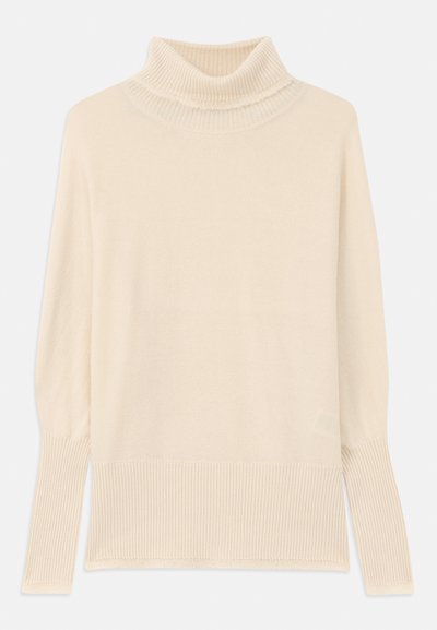 Krämfärgad polo-tröja med ribbade manchetter och nederkant. Mjuk textur, avslappnad passform och kraftig design på halsen. Lättstickad tyg.