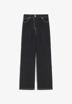 Black denim trousers featuring a wide-leg design, contrast white stitching, and traditional five-pocket styling. Textured fabric with a crinkled finish.