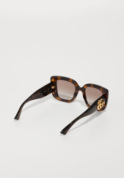  Schildpadbril met een vierkant model, straalverloop bruin lenzen en een gouden logo-accent aan de zijkant. Gaaf ontwerp met een gepolijste afwerking.