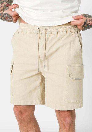 Beige cargo shorts made of cotton blend, featuring an elastic waistband with drawstring, side pockets, and a smooth texture.