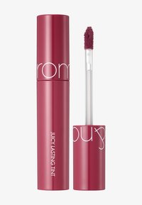 Putki huulimeikki punertavassa vaaleanpunaisessa sävyssä, kiiltävällä pinnalla. Kirkas applikaattori, jossa on pehmustettu pää helppoa levittämistä varten. Tunnuksessa lukee "Mehukas kestävä tintti."