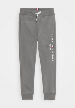 Grå sweatpants med elastisk talje og manchetter, hvid snor og vertikal Tommy Hilfiger-logo på venstre ben.
