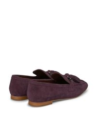 Suede loafers in a deep purple shade with a bow accent and two decorative tassels at the front, featuring a low wooden heel.