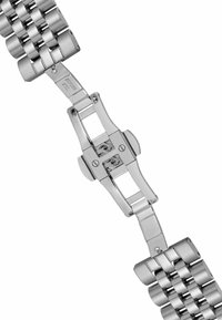 Bransoletka zegarka ze stali nierdzewnej z polerowanymi ogniwami i otwartym mechanizmem zapięcia, pokazującym elementy blokujące.
