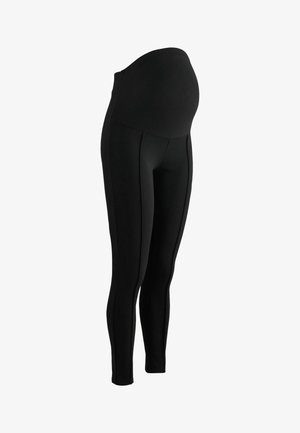 Leggings de maternité noirs avec une taille haute et extensible, conçues pour être ajustées, et avec des détails de couture sur les côtés pour plus de confort et d'ajustement pendant la grossesse.