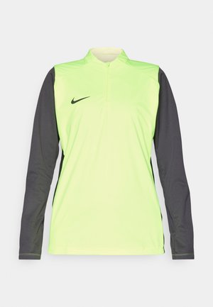 Dlhý rukáv športová mikina v neónovo žltej farbe s tmavosivými rukávmi. Obsahuje golier so štvrťzipsom a malým čiernym logom Nike na prednej strane.