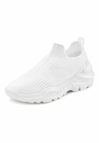 White slip-on sneakers with a ribbed knit upper, textured detailing, and a thick white rubber sole featuring a wavy design.