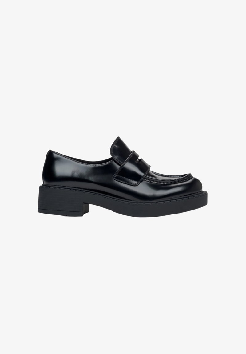 Black leather loafers with a chunky heel, featuring a stitched design and a midsole accent. Smooth texture and classic silhouette.