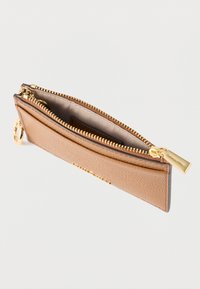 Portafoglio in pelle color cuoio con finitura testurizzata, accessori dorati e chiusura con cerniera. L'interno presenta una fodera liscia e scomparti per carte.