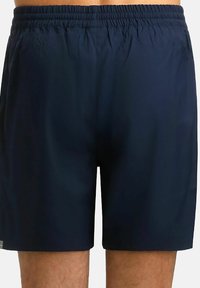 Pantaloni da bagno blu navy realizzati in tessuto leggero. Presentano una vita elastica e una vestibilità comoda, senza motivi visibili o elementi in metallo.