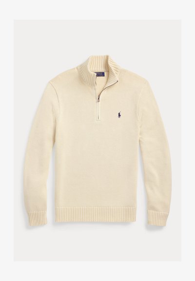 Kreemivärvi kootud pullover soonikkoega krae, varrukasäärte, alaosa ja neljandiku tõmblukuga ning väikese tikitud Polo Ralph Laureni logoga rinnal.