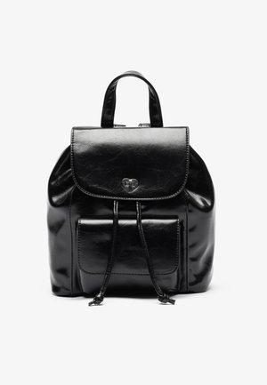 Black leather backpack with a front flap secured by a heart-shaped clasp and a front pocket, featuring two drawstrings and a top handle.