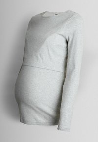 Helehall pikkade varrukatega topp soonilise tekstuuriga, mõeldud rasedatele, siluett on kehakuju järgiv ja ümara kaelusega.