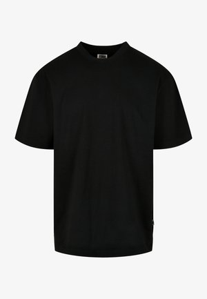 T-shirt noir en coton, avec un col rond et des manches courtes, à coupe ample. Design simple, sans motifs ni graphiques.