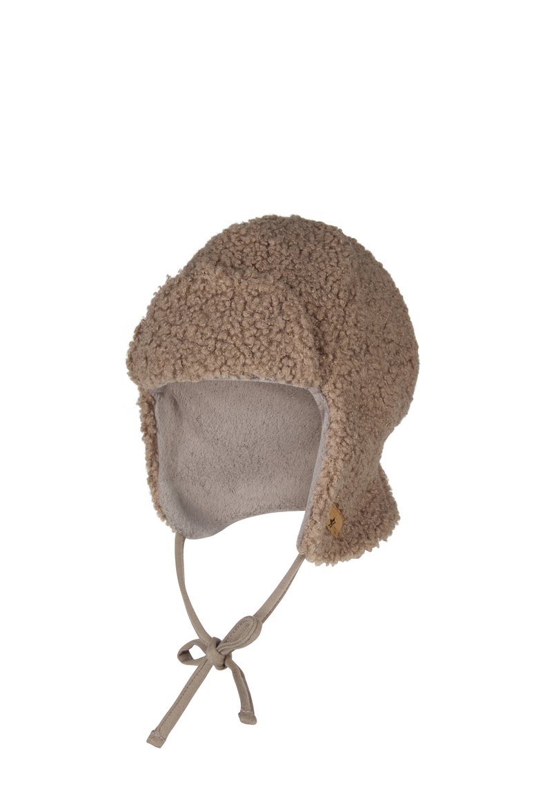 Fleece-lined hat made from textured brown shearling. Features ear flaps and a chin tie, with a small logo detail near the base.