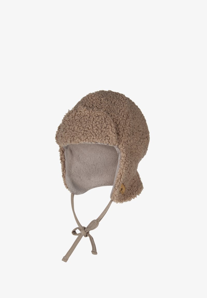 Fleece-lined hat made from textured brown shearling. Features ear flaps and a chin tie, with a small logo detail near the base.