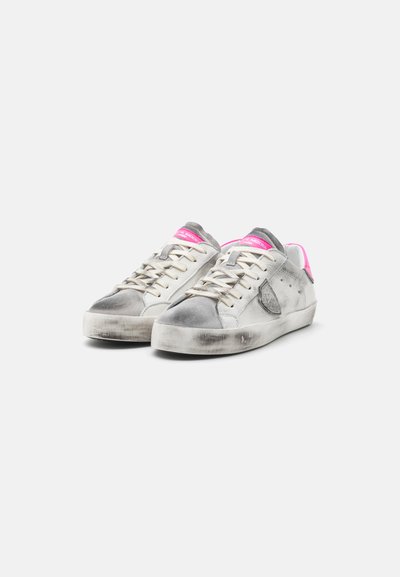 Silver and white sneakers with pink accents, suede and leather materials, round toe, flat sole, and visible wear on surfaces.